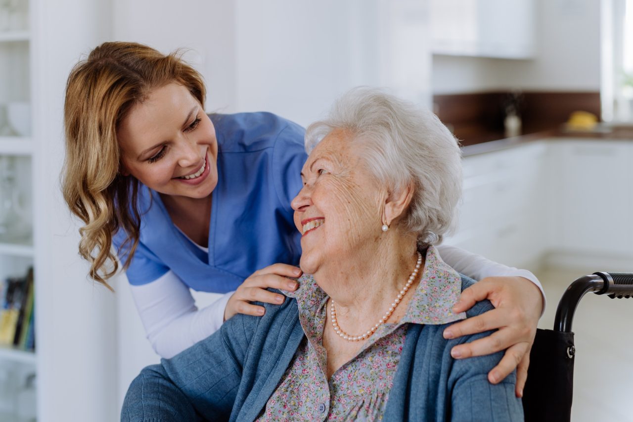 portrait of nurse and her senior client on wheelchair .jpg
